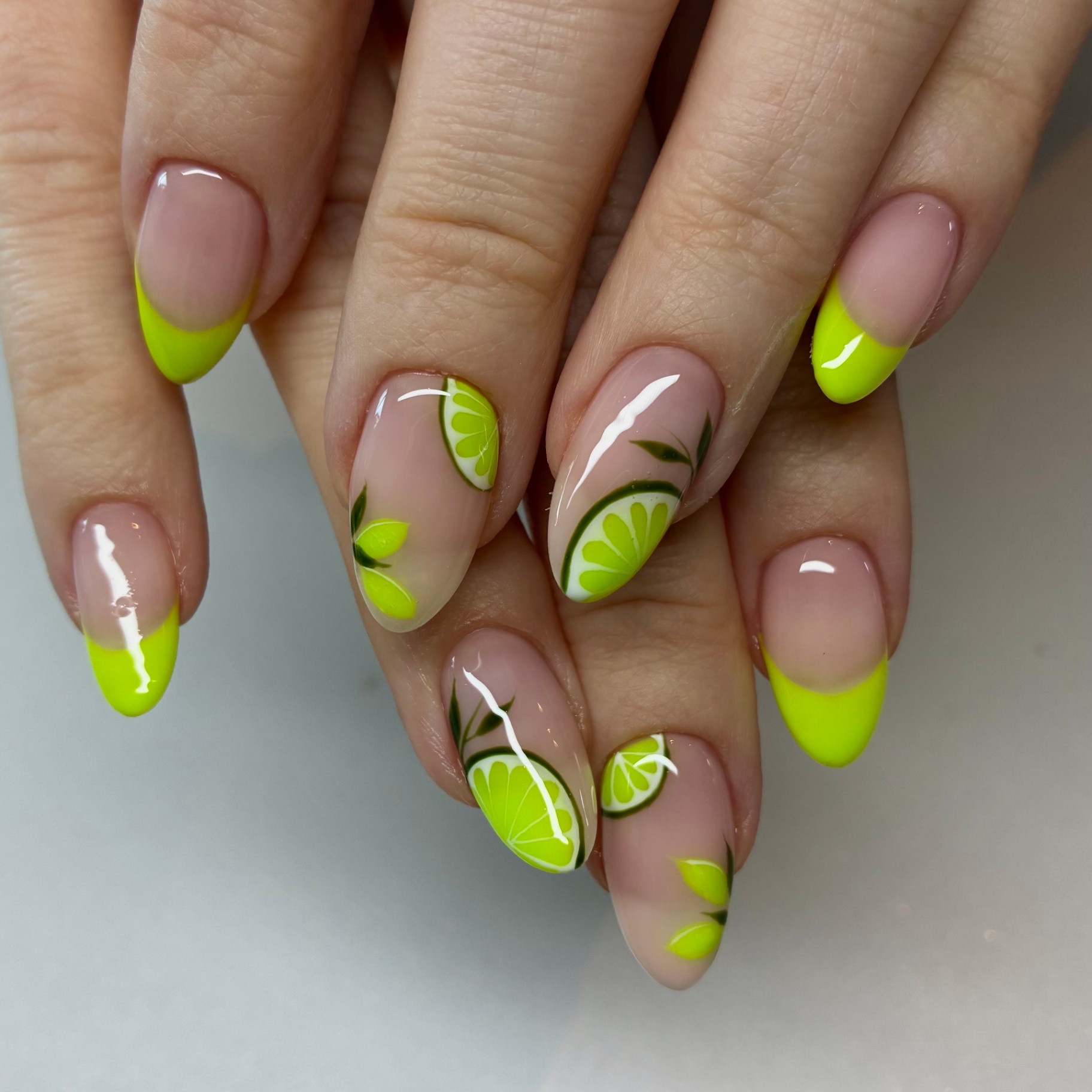 Neon lime french tips with citrus slice accent nails