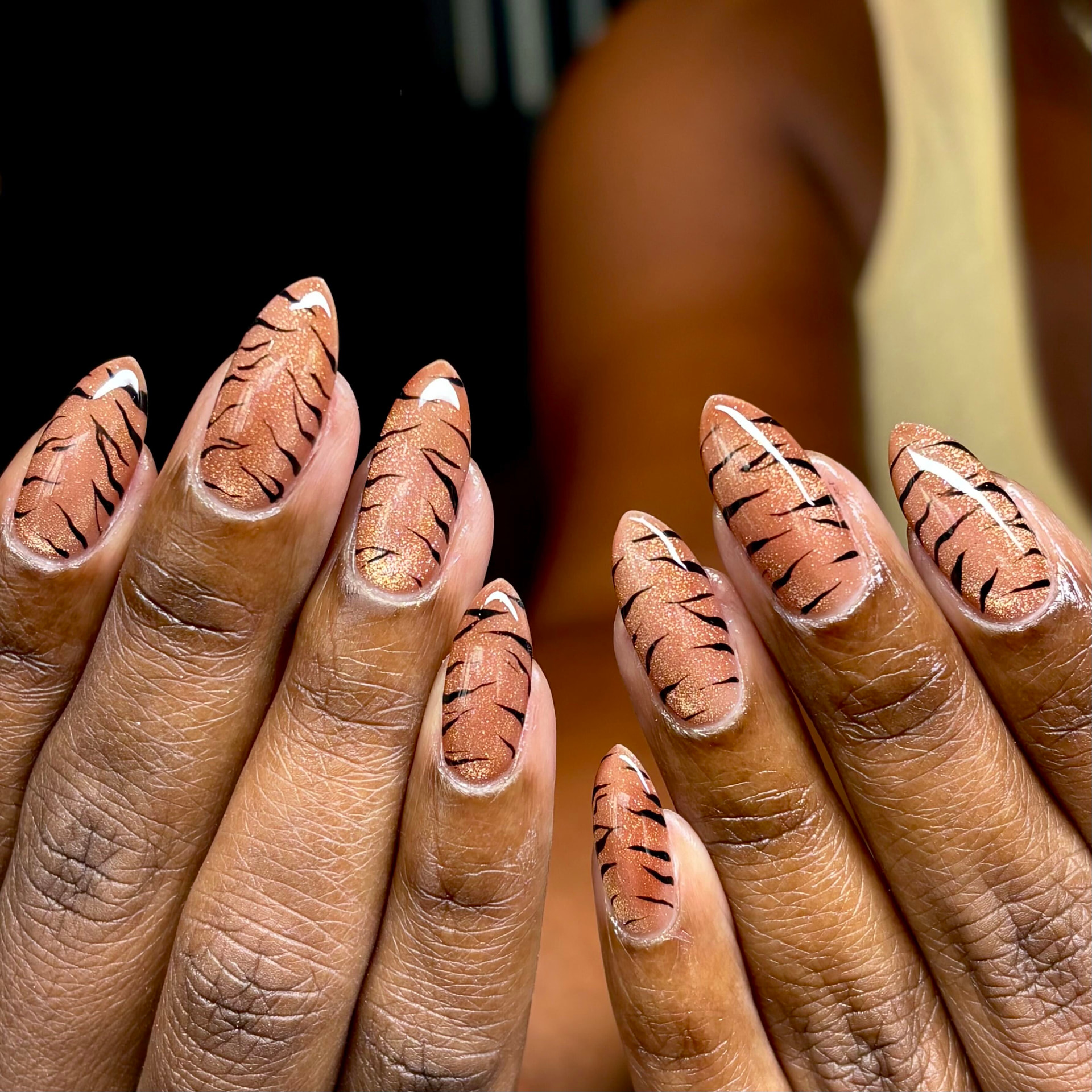 Copper glitter nails with hand-painted black tiger stripes